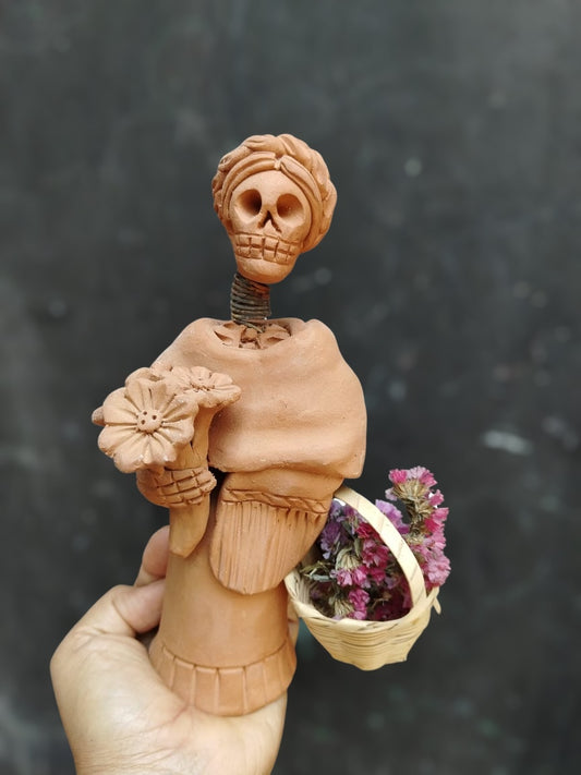 Imelda (basket on the side, Oaxacan skull)